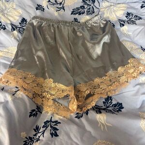 Blue satin mini shorts with cream lace hem